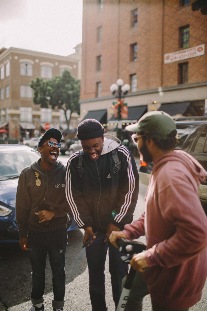 3 young men in a city laughing